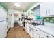 Well-lit kitchen with white cabinets and modern appliances adjacent to a cozy dining area at 6766 Little Mountain Rd, Sherrills Ford, NC 28673