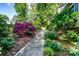 Landscaped yard with vibrant flowers and a well-maintained walkway leading to the home at 6766 Little Mountain Rd, Sherrills Ford, NC 28673