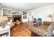 Cozy living room featuring hardwood floors, brick fireplace with built-in shelving, and comfortable furnishings at 6766 Little Mountain Rd, Sherrills Ford, NC 28673