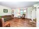 Bright living room with hardwood floors, brick fireplace, and an inviting atmosphere for relaxing and entertaining at 6766 Little Mountain Rd, Sherrills Ford, NC 28673