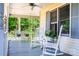 Cozy porch with a swing, rocking chairs, and views of the peaceful surroundings at 6766 Little Mountain Rd, Sherrills Ford, NC 28673