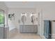 Bright bathroom featuring a double vanity, large soaking tub, and a picture window offering natural light at 7049 Sedgebrook W Dr, Stanley, NC 28164