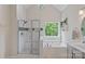 Bright and open bathroom with a glass enclosed shower and a soaking tub with large picture window at 7049 Sedgebrook W Dr, Stanley, NC 28164
