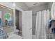 Gray-toned bathroom with modern fixtures, a tub shower with a white curtain, and updated vanity at 7049 Sedgebrook W Dr, Stanley, NC 28164