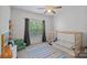 Bright bedroom featuring a custom-built bed frame, colorful decor, and a cozy reading corner at 7049 Sedgebrook W Dr, Stanley, NC 28164