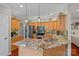 Spacious kitchen featuring granite countertops, wood cabinets, and stainless steel appliances at 7049 Sedgebrook W Dr, Stanley, NC 28164