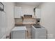 Modern laundry room featuring a front load washer and dryer, open shelving, and stylish decor at 7049 Sedgebrook W Dr, Stanley, NC 28164