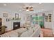 Bright living room featuring a fireplace, hardwood flooring, and a large window overlooking the yard at 7049 Sedgebrook W Dr, Stanley, NC 28164