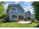 This backyard features a screened-in porch, a stone patio with dining furniture and well-maintained lawn at 710 Morgan Park Dr, Charlotte, NC 28204