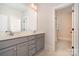 Bathroom featuring a double sink vanity with gray cabinets and tiled floor at 710 Morgan Park Dr, Charlotte, NC 28204