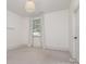 Neutral bedroom with carpeted floor, one window with linen drapes, and white walls at 710 Morgan Park Dr, Charlotte, NC 28204