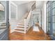 Inviting foyer with hardwood floors, staircase, and natural light from a large window at 710 Morgan Park Dr, Charlotte, NC 28204