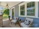 Charming covered front porch featuring comfortable wicker chairs and inviting decor at 710 Morgan Park Dr, Charlotte, NC 28204