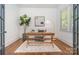A home office space with a wooden desk, area rug, and a large window at 710 Morgan Park Dr, Charlotte, NC 28204