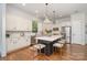 An open kitchen featuring an island with bar seating, stainless steel appliances, and hardwood floors at 710 Morgan Park Dr, Charlotte, NC 28204