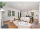 Bright living room with fireplace, hardwood floors, and open view into the modern kitchen at 710 Morgan Park Dr, Charlotte, NC 28204