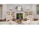 Cozy living room with a fireplace, built-in bookshelves, and neutral decor at 710 Morgan Park Dr, Charlotte, NC 28204