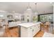 Open-concept living space featuring an island, hardwood floors, a living room with a fireplace, and a dining area at 710 Morgan Park Dr, Charlotte, NC 28204