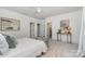 A bright bedroom with a neutral color palette, accent furniture, and hardwood floors at 710 Morgan Park Dr, Charlotte, NC 28204