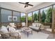Inviting screened porch with ceiling fan, wood framing, and comfortable wicker furniture at 710 Morgan Park Dr, Charlotte, NC 28204