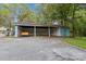 Spacious open carport with a swing and a small storage shed attached at 712 Grace Ave, Kannapolis, NC 28083