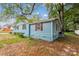 Side view of a blue home with brown shutters and green landscaping at 712 Grace Ave, Kannapolis, NC 28083