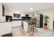Well-lit kitchen with modern appliances, granite counters, and an island with bar seating offering a functional space at 712 Grace Ave, Kannapolis, NC 28083