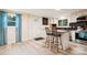 Bright kitchen with island bar seating, stainless appliances, and backyard views through a large window at 712 Grace Ave, Kannapolis, NC 28083