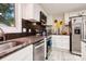 Modern kitchen with granite countertops, stainless steel appliances, and ample natural light, providing a chef's dream at 712 Grace Ave, Kannapolis, NC 28083