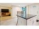 Open-concept kitchen and living room with laminate wood floors and a kitchen island with barstool seating at 712 Grace Ave, Kannapolis, NC 28083