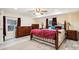 Comfortable main bedroom featuring a ceiling fan, dresser, and large windows at 712 Grace Ave, Kannapolis, NC 28083