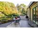Charming backyard patio area with outdoor seating surrounded by lush landscaping at 714 Larkhall Ln, Charlotte, NC 28211