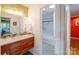 Modern bathroom with a vanity with a stone countertop, and a doorway leading to the tub-shower at 714 Larkhall Ln, Charlotte, NC 28211