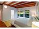 Bedroom featuring hardwood floors, wooden ceilings, neutral colors and view of outdoor greenery at 714 Larkhall Ln, Charlotte, NC 28211