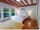 Bedroom featuring hardwood floors, wooden ceilings, and a large window providing scenic view at 714 Larkhall Ln, Charlotte, NC 28211