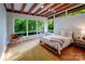 Bright bedroom with wooden ceilings, hardwood floors, large windows, and natural light at 714 Larkhall Ln, Charlotte, NC 28211