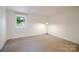 Cozy bedroom with carpet and natural light from a window overlooking greenery at 714 Larkhall Ln, Charlotte, NC 28211