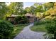 Beautiful home exterior with a stone walkway and lush landscaping at 714 Larkhall Ln, Charlotte, NC 28211