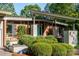 Brick home featuring a modern architectural style with landscaped front yard and a striking turquoise front door at 714 Larkhall Ln, Charlotte, NC 28211
