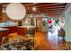 Open concept kitchen with a central island, wood cabinetry, stainless steel appliances, and an adjacent dining area at 714 Larkhall Ln, Charlotte, NC 28211