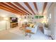 Bright living room featuring exposed wood beams, neutral tones, and natural light from surrounding green spaces at 714 Larkhall Ln, Charlotte, NC 28211