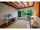 Office room with wooden ceilings, hardwood floors, large windows, and views of outdoor greenery at 714 Larkhall Ln, Charlotte, NC 28211