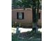 Exterior view of a brick home with black shutters and mature trees at 730 Harris Rd, Salisbury, NC 28147