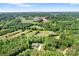 Breathtaking aerial view showcases home's location with surrounding lush trees, and expansive acreage at 730 Oak Ridge Farms Cir # 14, Newton, NC 28658