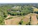 Stunning aerial view of a property with a long drive surrounded by lush trees and green pastures at 730 Oak Ridge Farms Cir # 14, Newton, NC 28658