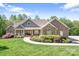 Charming brick and stone home with a manicured lawn and inviting front porch, perfect for enjoying peaceful surroundings at 730 Oak Ridge Farms Cir # 14, Newton, NC 28658