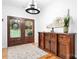 Elegant foyer featuring hardwood floors, a stylish chandelier, and a decorative wooden console table at 730 Oak Ridge Farms Cir # 14, Newton, NC 28658