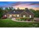 Charming brick home at sunset features a landscaped yard, covered porch, and inviting curb appeal at 730 Oak Ridge Farms Cir # 14, Newton, NC 28658