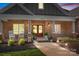Inviting covered front porch with rocking chairs, decorative plants, and double doors at 730 Oak Ridge Farms Cir # 14, Newton, NC 28658