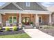Inviting front porch featuring rocking chairs, a brick facade, and decorative planters creating a cozy entrance at 730 Oak Ridge Farms Cir # 14, Newton, NC 28658